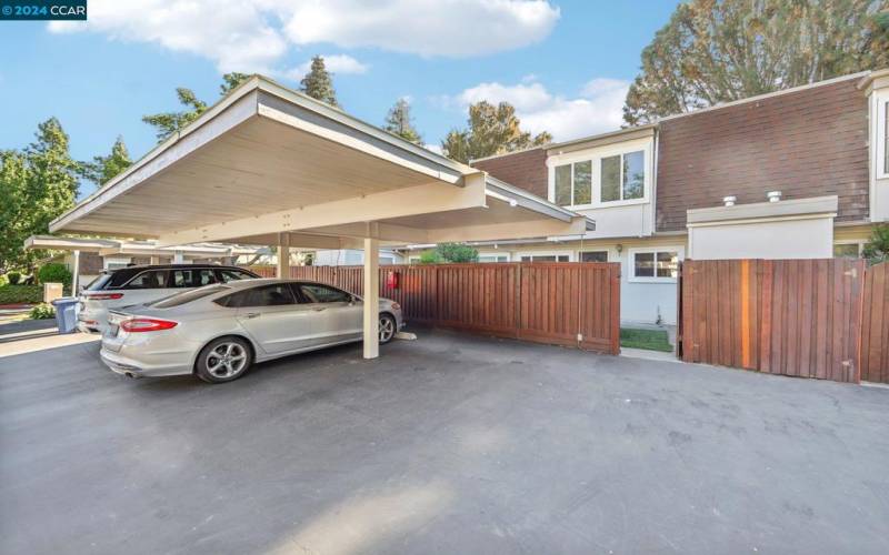 Covered carport & uncovered space Behind open gate