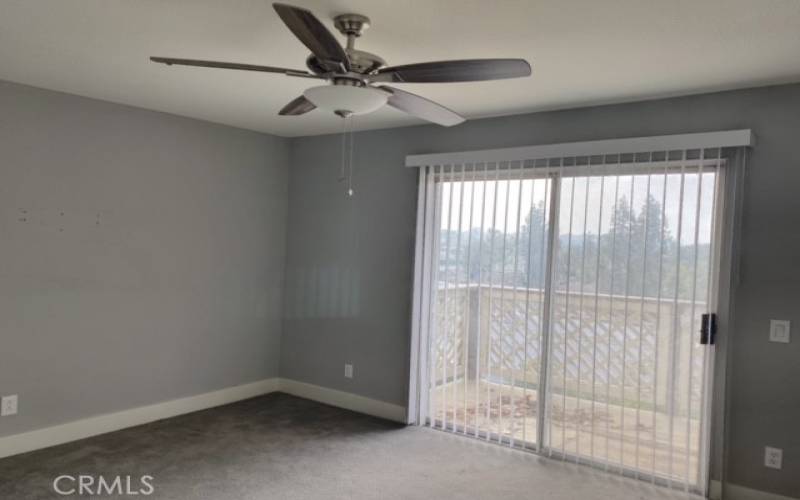 Bedroom with Ceiling Fan and Sliding Doors to Balcony