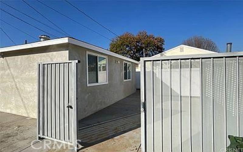 Alley entry with carport, and gate.