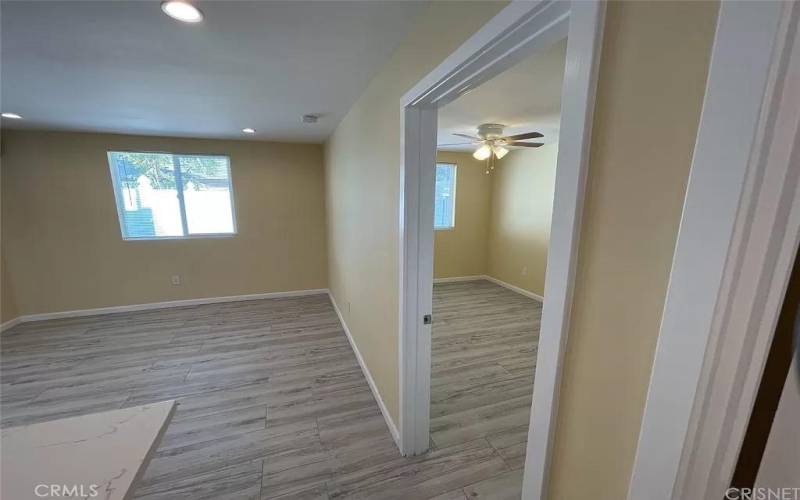 View from kitchen into the living room, and bedroom.