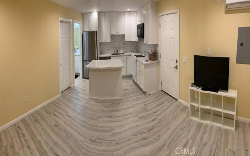 View from kitchen into the living room, and bedroom.