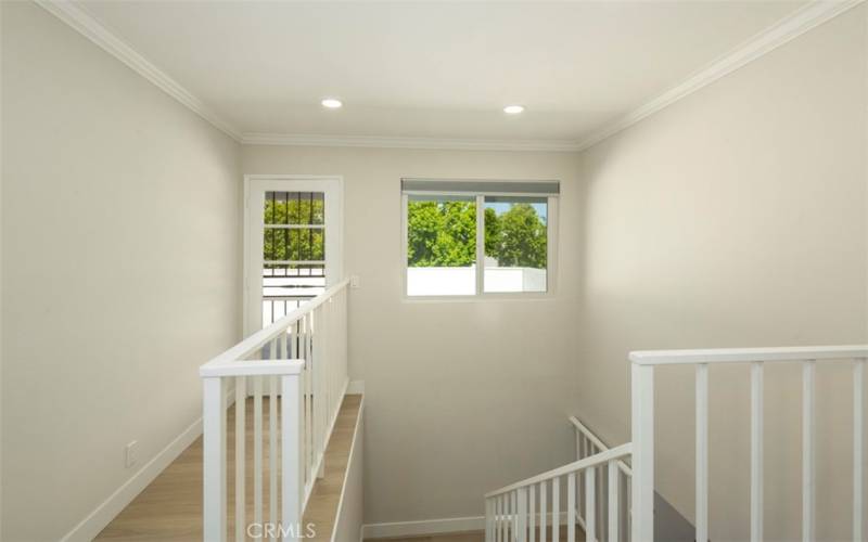 At top of the stairs is the deck entrance for the secondary bedrooms or visitors.