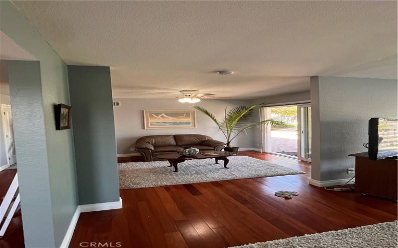 As you enter the open living area beveled glass doors shine upon the beautiful wood flooring.