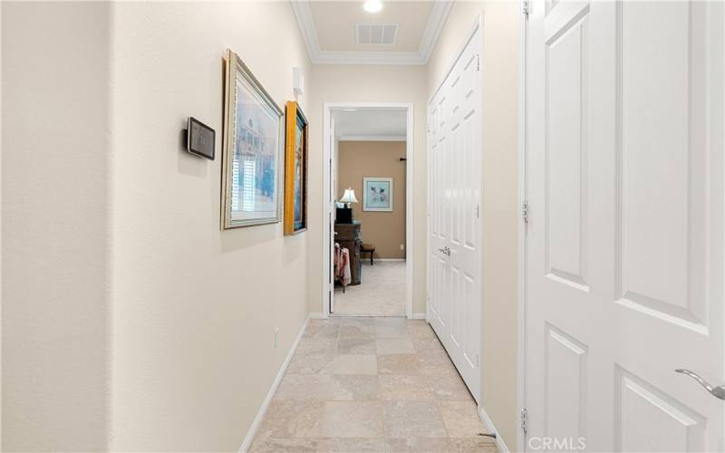 Hallway to Primary Bedroom has Double Door Linen Closet and separate Coat Closet