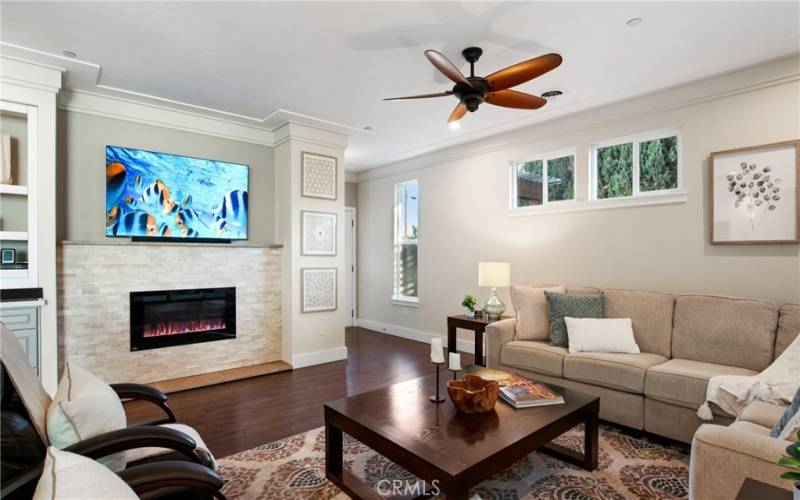 View of great room with fireplace and custom tile work.