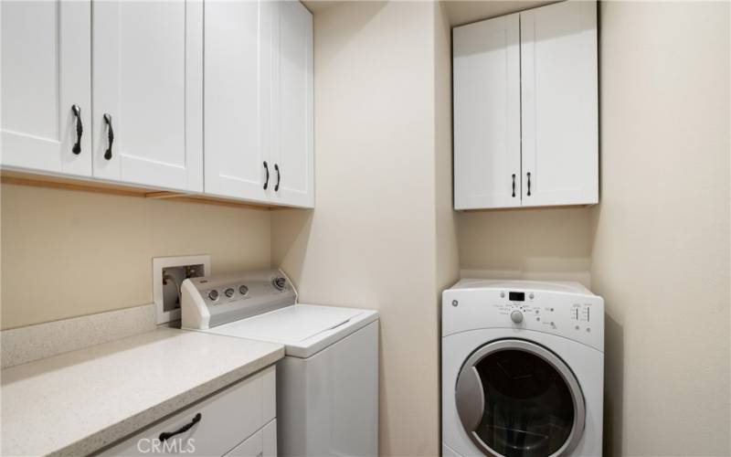 Excellent laundry with storage and folding area.