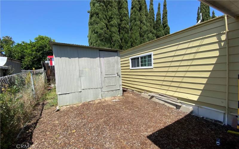 Left Rear Side of Home with Storage Unit