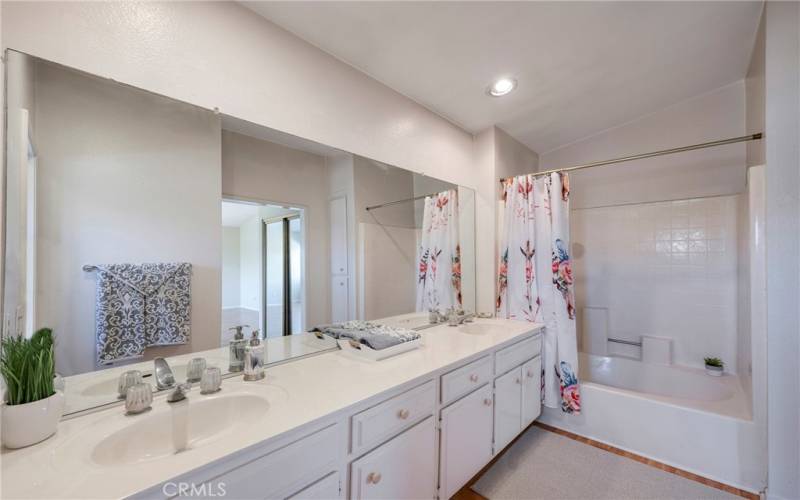 Main bathroom has dual sinks & tub/shower.