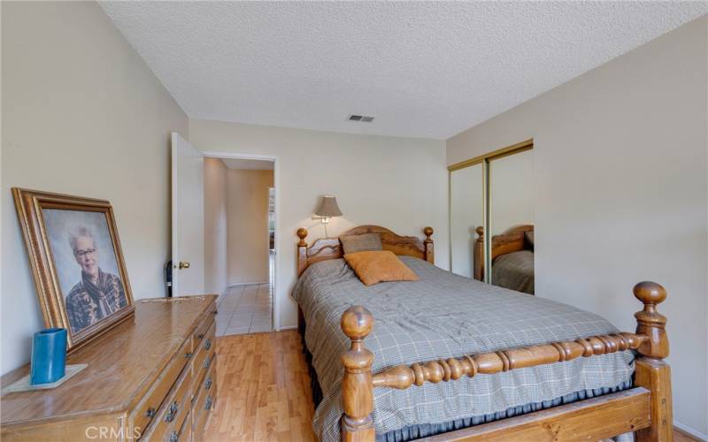 Bedroom 1 has mirrored closet doors & pergot flooring.