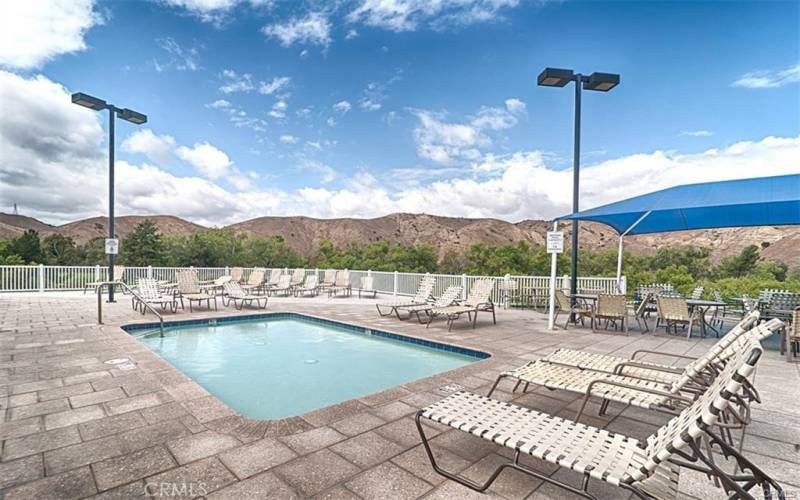 Children’s pool by BBQ AREA with tables and chairs for dining.