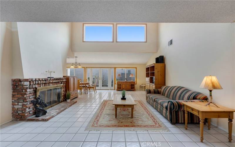 Living room has extra windows in high cathedral ceiling.