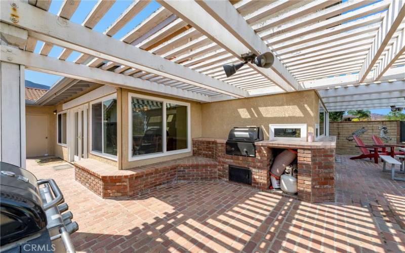 Side yard leads to beautiful brick patio & built in BBQ AREA.