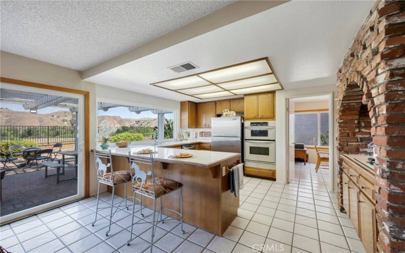 Kitchen boasts breakfast bar, & stainless steel appliances, including Refrigerator.