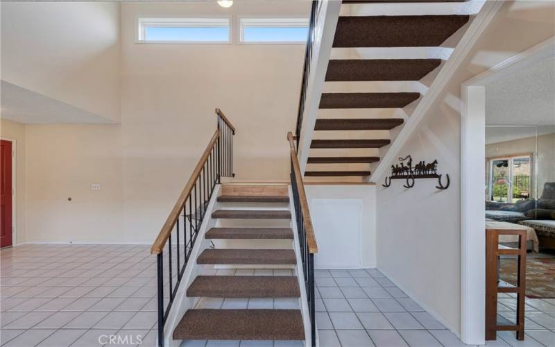 Storage cabinet to right under stairs.