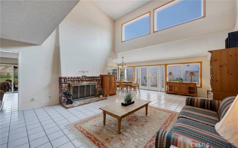 Living room has tiled flooring & kitchen/ family room to left.