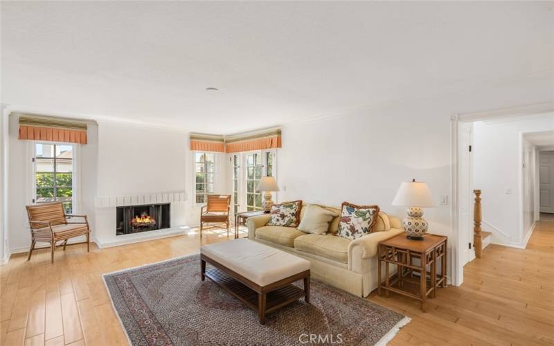 Family room with a fireplace next to the kitchen