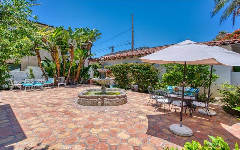 Spacious yard with fountain, mature trees