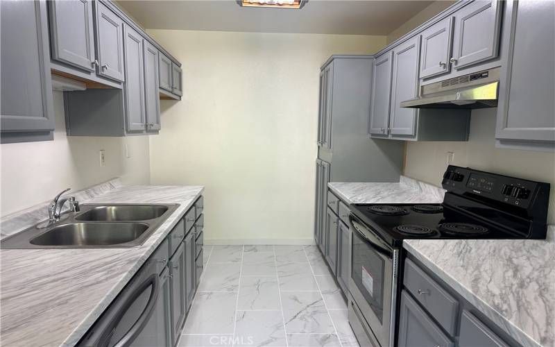 Updated galley kitchen, dishwasher, electric range.