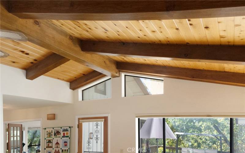 Wood bean ceilings and access to the private deck surrounded by 3 rooms.