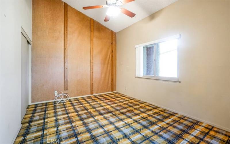 The first bedroom has a vaulted ceiling and a sunny window.