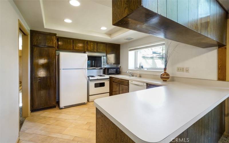 The kitchen has recessed lighting, pantry, and plenty of cabinetry. Includes the refrigerator, stove/oven, dishwasher and microwave.