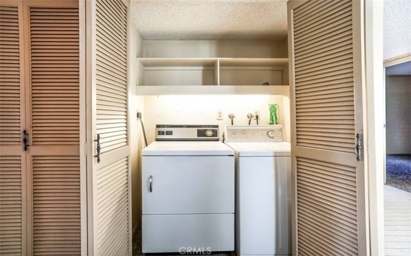 The laundry area is tucked away behind doors for easy access.