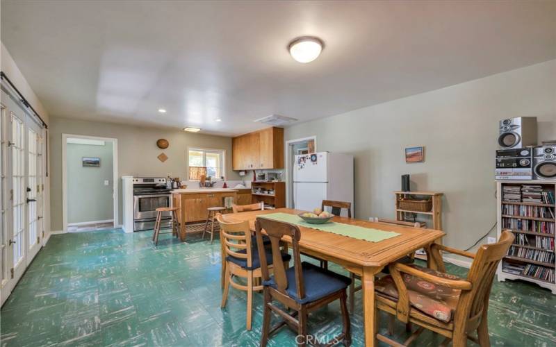 Country kitchen, left side door to backyard. Right doorway near sink to bedroom and 2nd bath, stacked laundry in hallway, back door way in corner of room leads to third bedroom