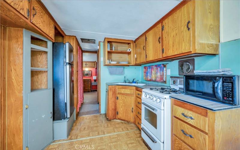 Guest trailer on the property, living space, dining area, one bathroom and bedroom in back