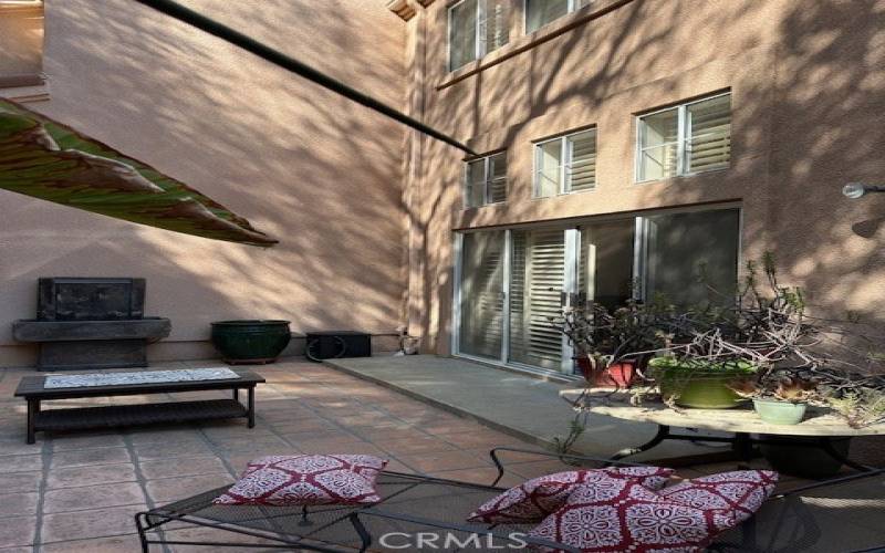 Patio yard looking toward glass slider doors to the unit