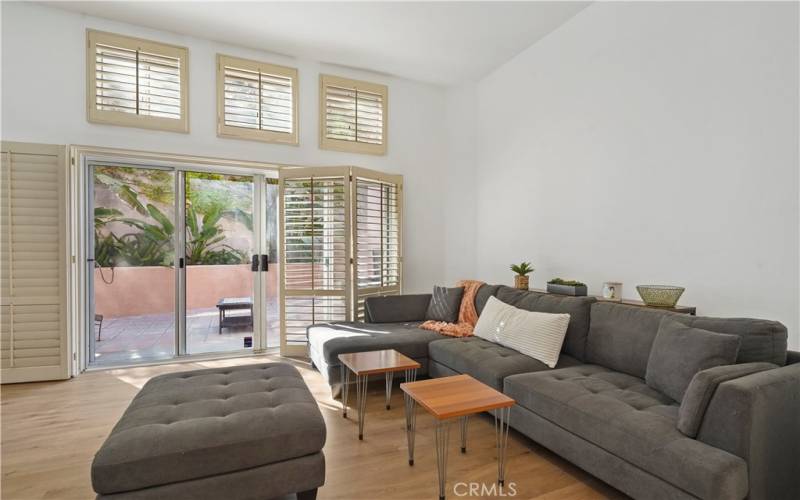 Vaulted ceiling living room with big slider door to private patio yard