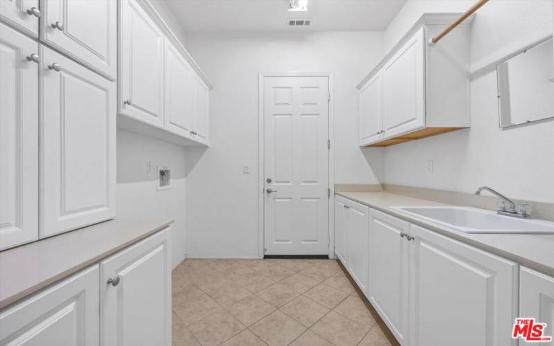 Custom floor to ceiling cabinets in laundry room