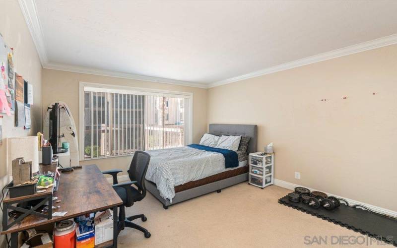 Second bedroom with large closet and view to the pool.