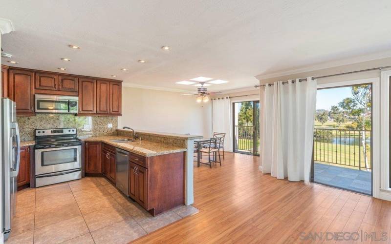 kitchen transitions seamlessly to dining area and bay window views to La Costa golf course.