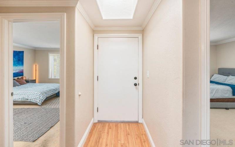 Primary and secondary bedroom flank both sides of entry-way.  Both rooms have views to the pool.