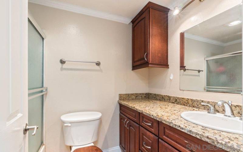 Primary bath with full shower and granite counter-tops.