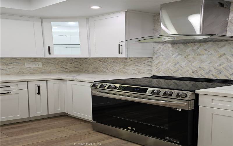 Note the Lit Upper Corner glass door and skinny lower base cabinet with a pull-out spice rack on left side of the oven