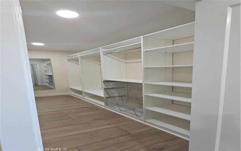 Master-Bedroom Walk-in Closet - Right View w pull-out Wire Basket, loads of clothes rod hangar space & moveable shelving