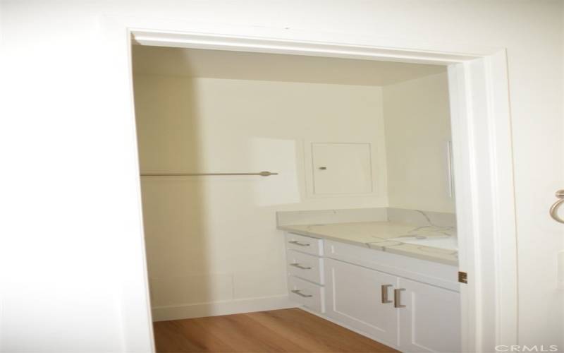 The second vanity and sink area includes the toilet and shower.