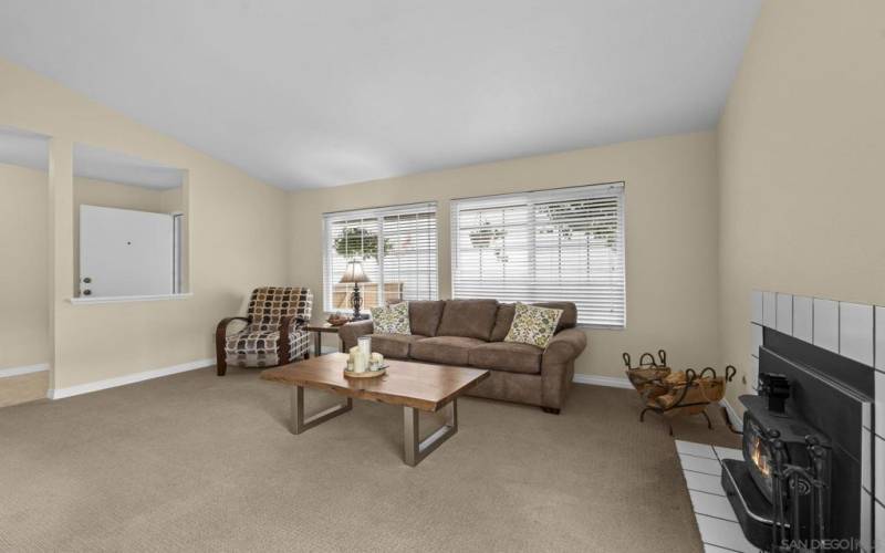 Spacious living room-Open floor plan into the kitchen/dining area. Vaulted ceilings in the living room