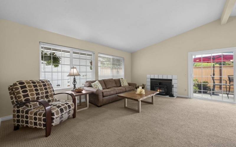 Spacious living room-Open floor plan into the kitchen/dining area. Sliding door opens up to the patio. Vaulted ceilings in the living room