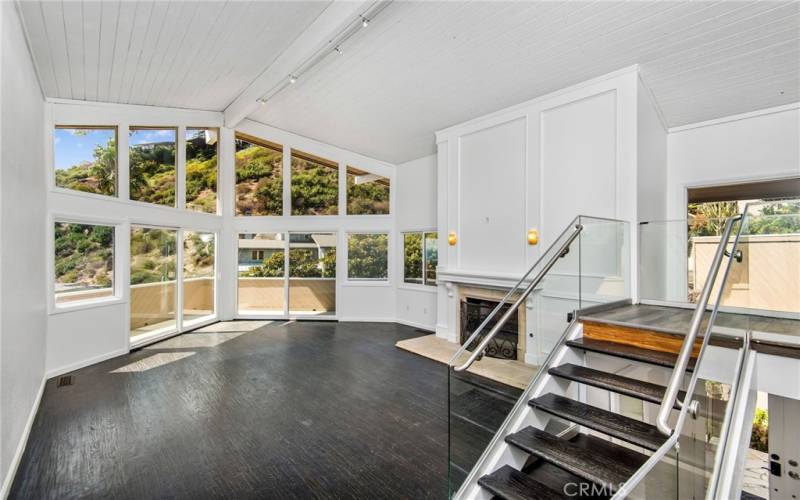 Ocean view living room with gas fireplace and vaulted ceilings