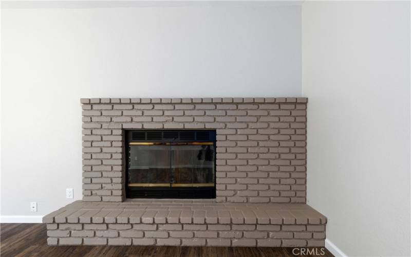 Large wood burning fireplace in family room.