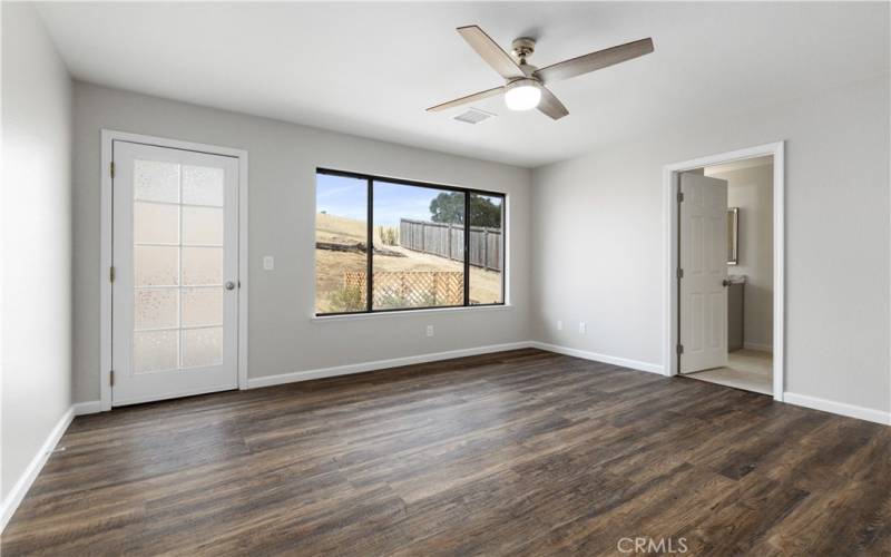 Primary bedroom with door to backyard.