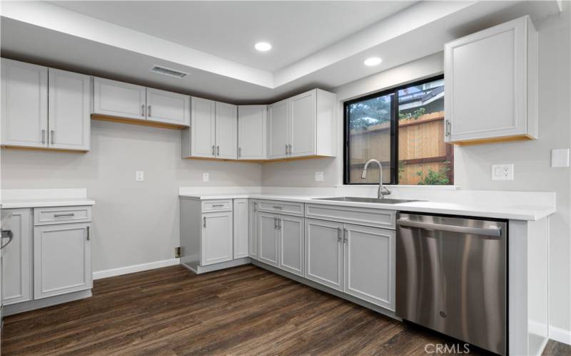 Kitchen is all new; cabinets, coved ceiling, stainless steel appliances and Corian counter tops.