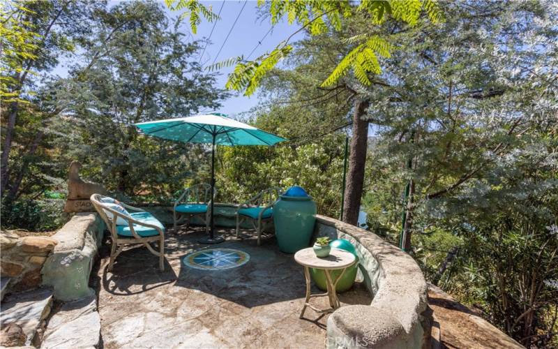 Sitting area with view of lake. Custom Malibu style tile medallion 