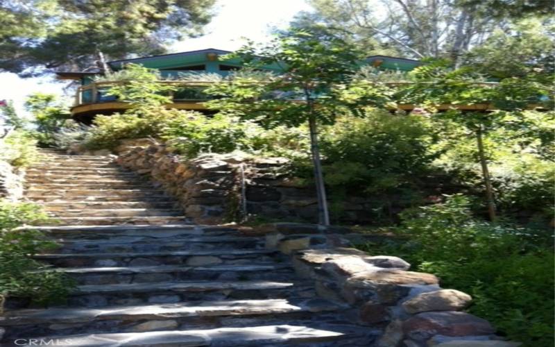 Photo taken 2016 Cabin visible above garden steps of Sydney Peak flagstone with 