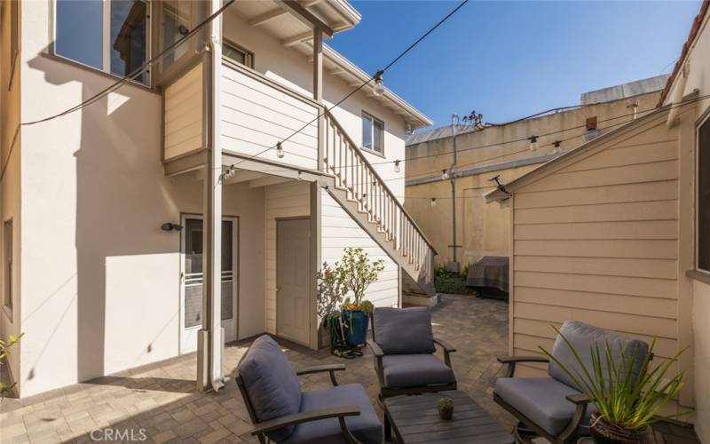 Shared courtyard area with lower unit