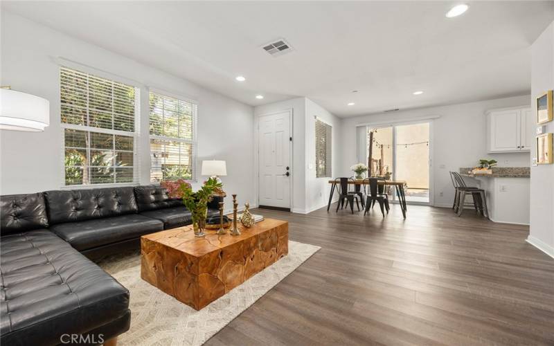 Great room looking toward your front entry and dining area. Sliders lead out to your private patio. Luxury flooring throughout the lower level.