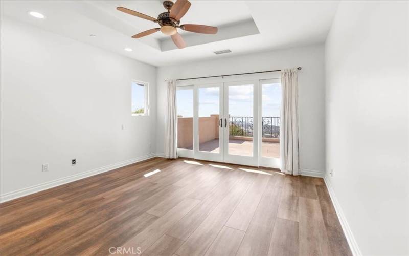 Another upstairs bedroom with balcony leading to panoramic views.