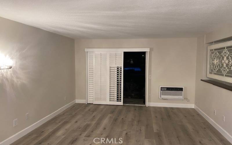 Living Room area - with plantation shutters on Sliding Glass Door.